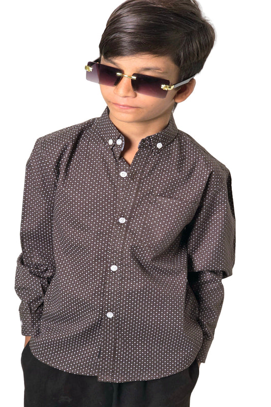 Person wearing a patterned shirt and sunglasses against a plain background