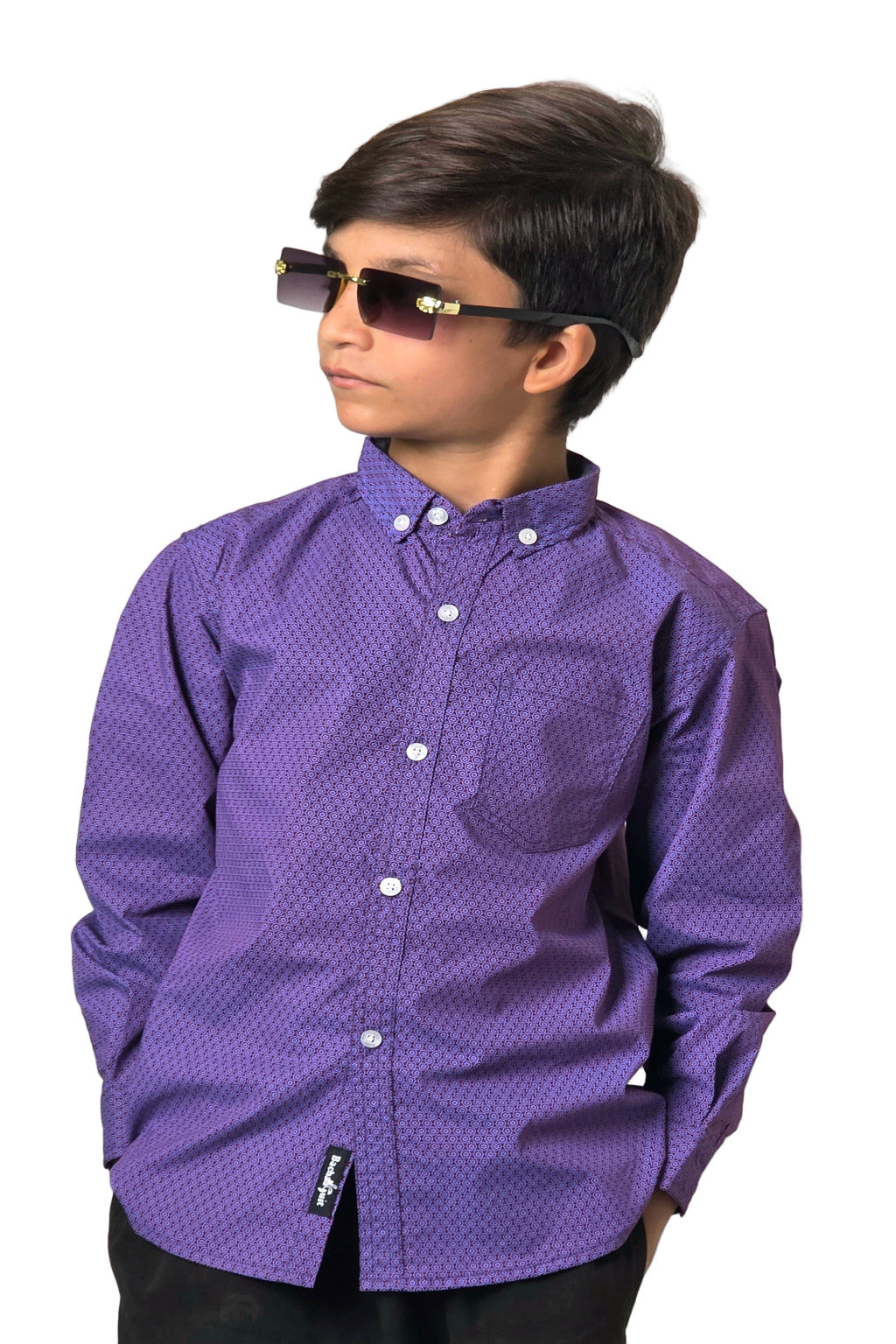 Child wearing a purple patterned shirt with sunglasses on a plain background