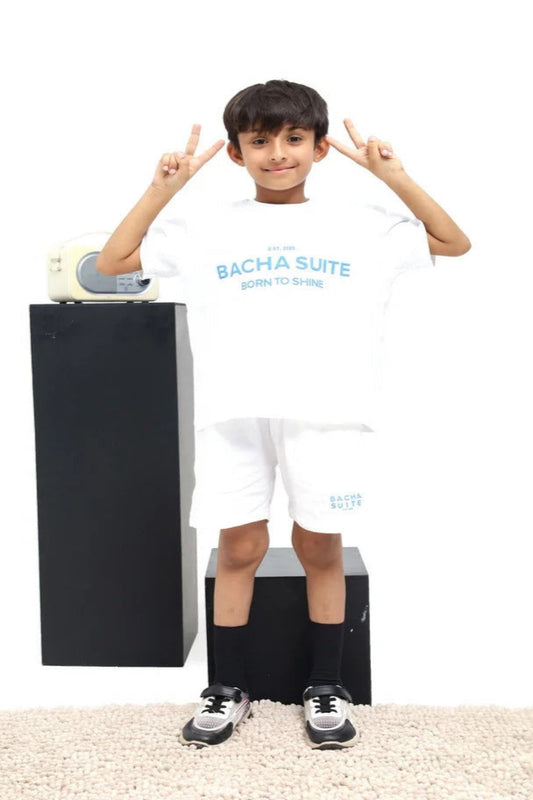 Child wearing a white t-shirt with 'Bacha Suite' branding, standing next to a black box on a white background.