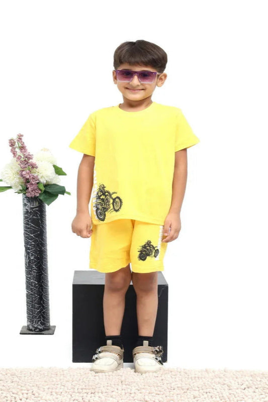 Child wearing a yellow outfit with floral decorations on a white background