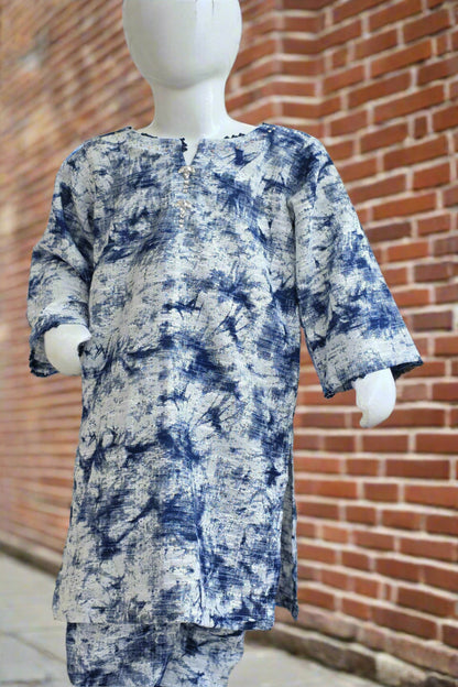 Mannequin wearing a blue and white patterned outfit against a brick wall.