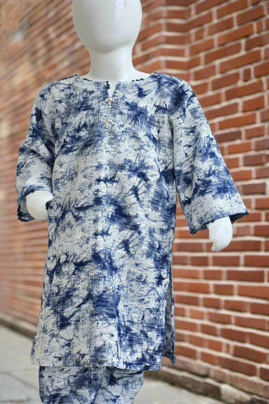 Mannequin wearing a blue and white patterned outfit against a brick wall.