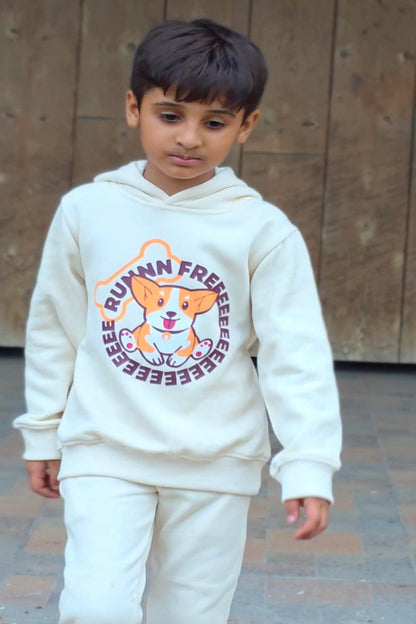 Child wearing a white hoodie with a dog graphic and text outdoors.